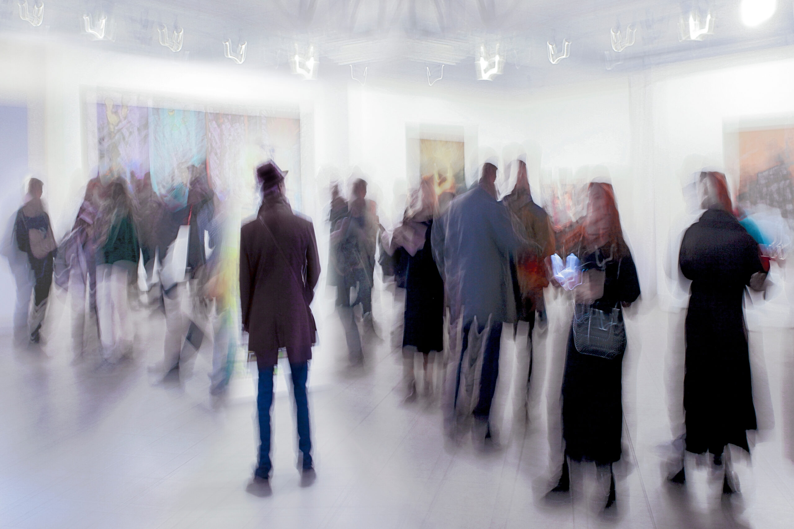 abstract image of people in the lobby of a modern art center with a blurred background